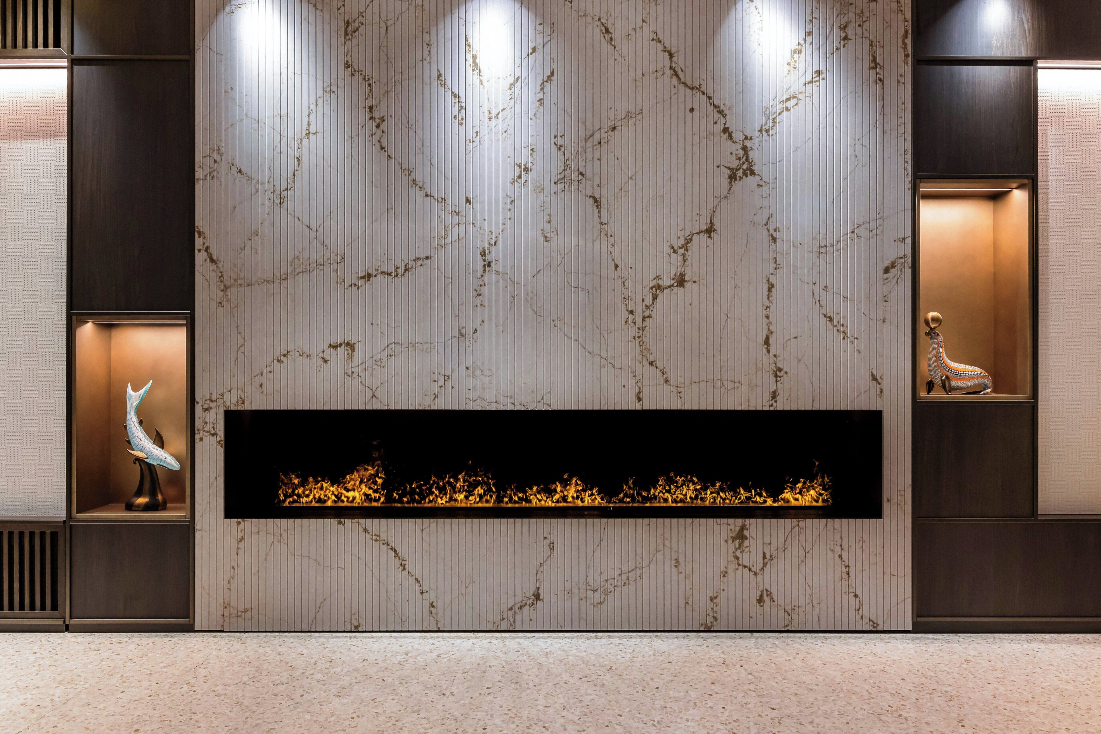 Een modern interieur met een open haard, decoratieve wandpanelen en een beeldhouwwerk.