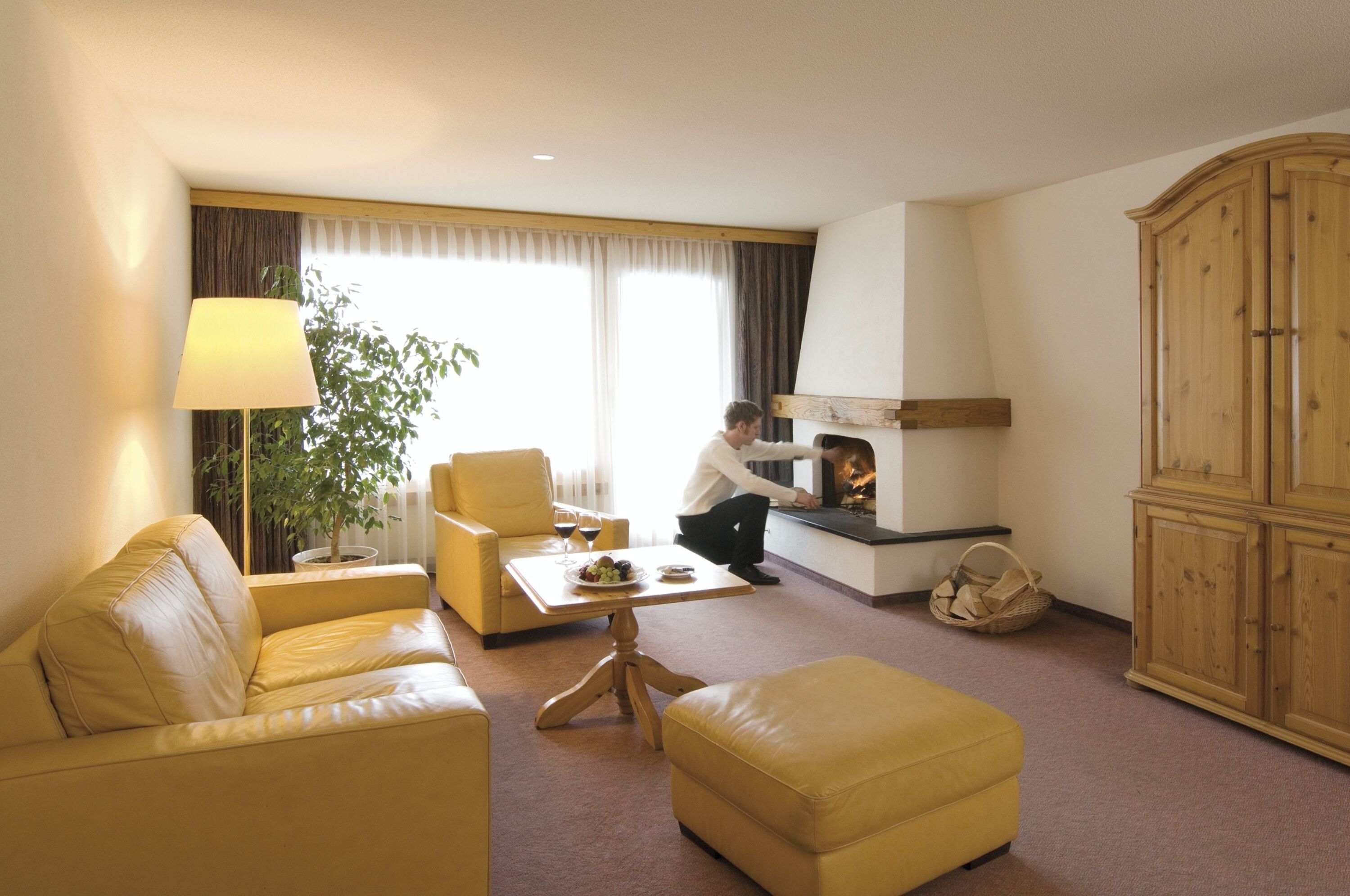 exclusive suite | living area | flat-screen tv, fireplace, heated floors