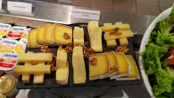 Una exposición de quesos con diferentes tipos de queso y nueces.