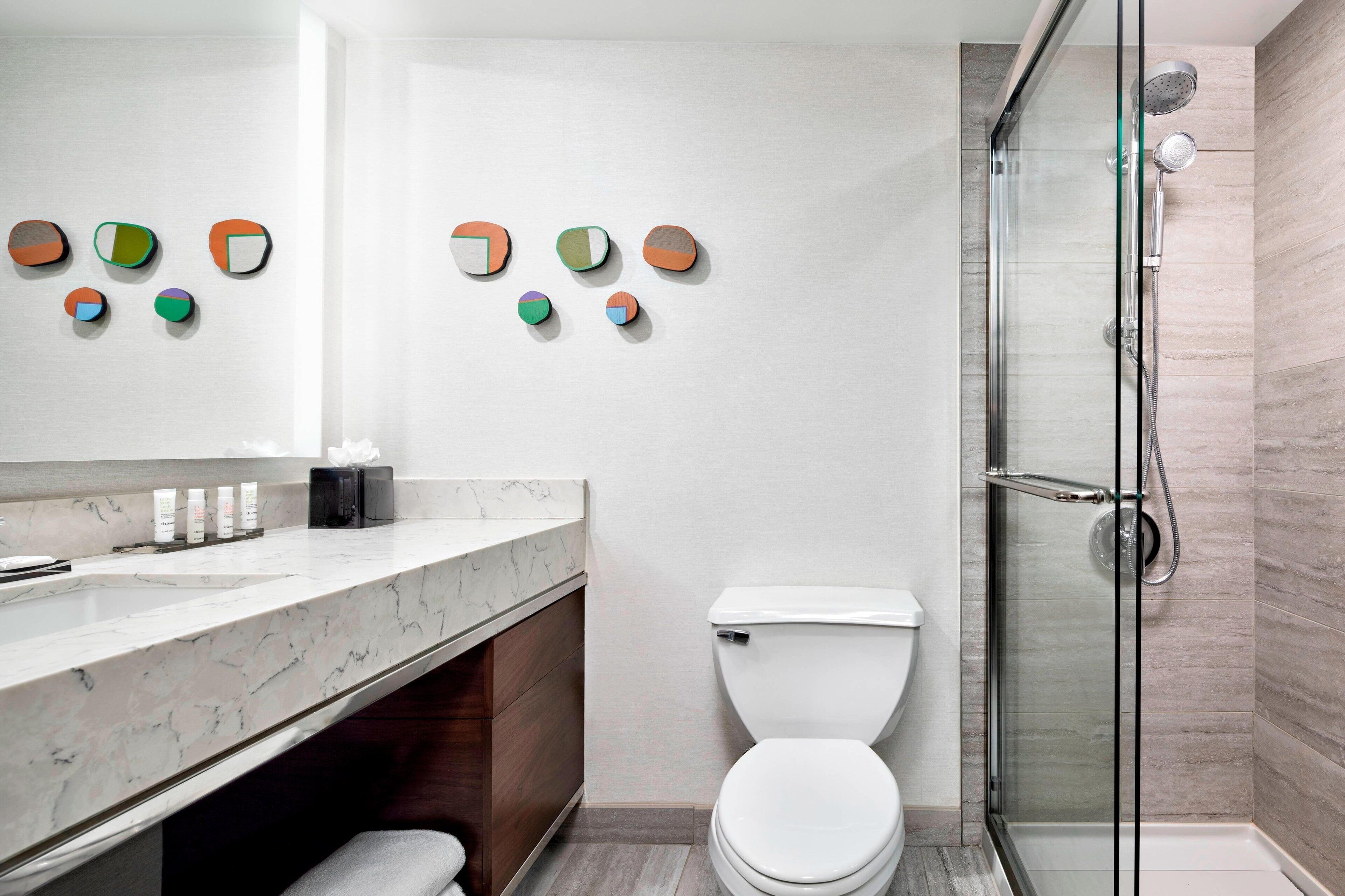 combined shower/bathtub, designer toiletries, hair dryer, towels