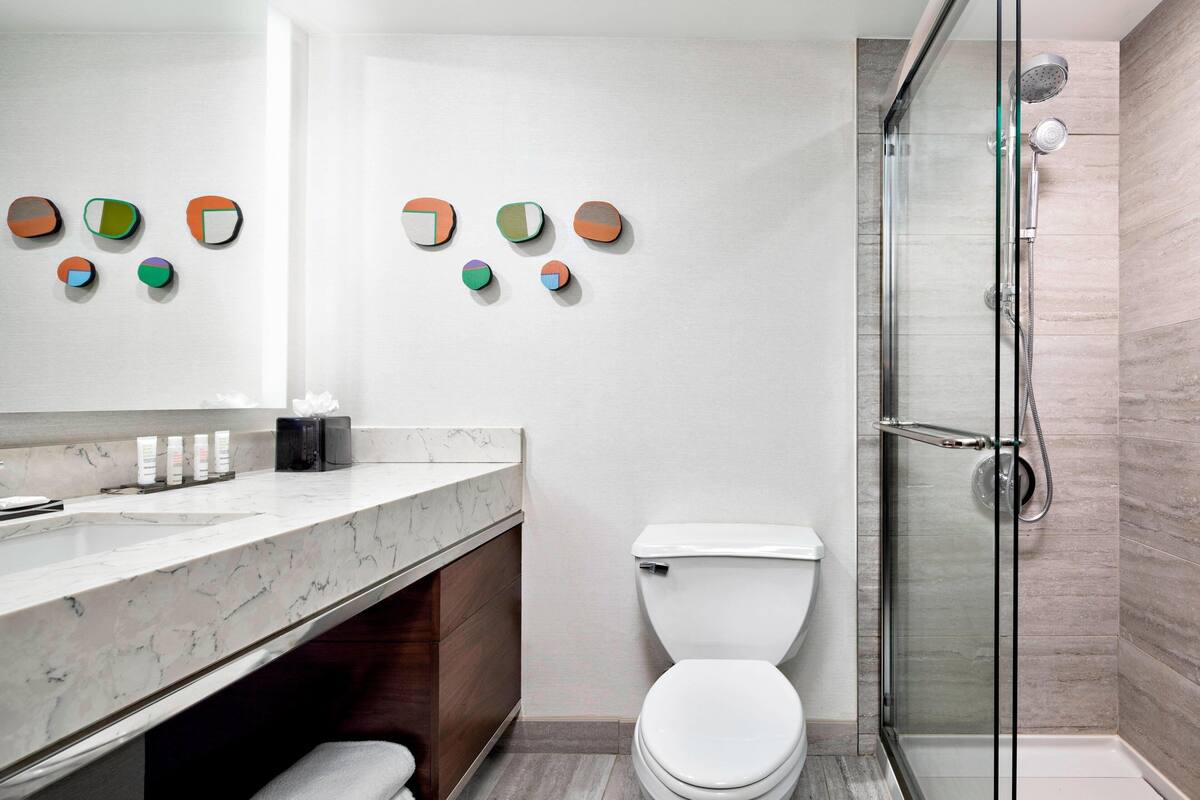 combined shower/bathtub, designer toiletries, hair dryer, towels