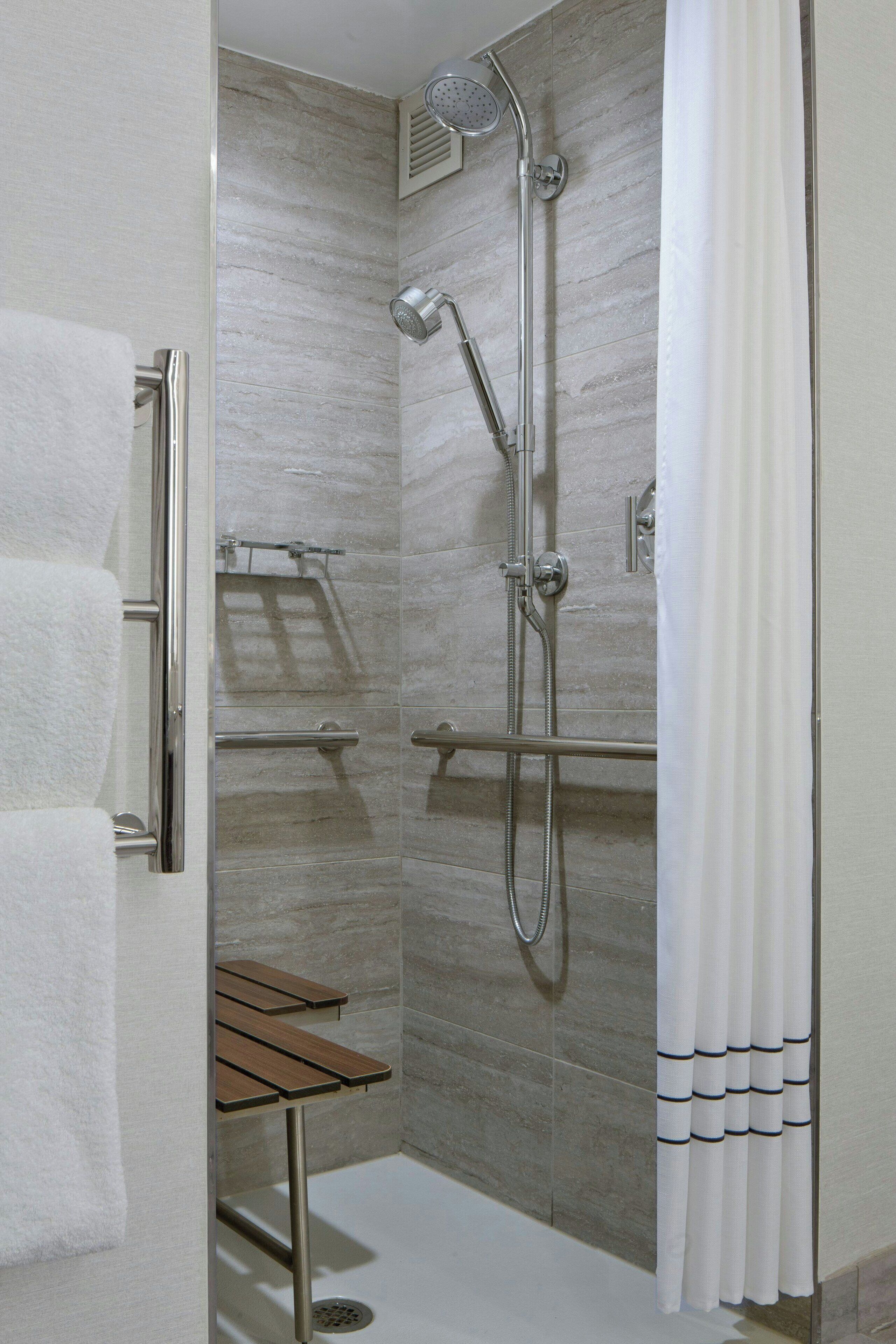 combined shower/bathtub, designer toiletries, hair dryer, towels