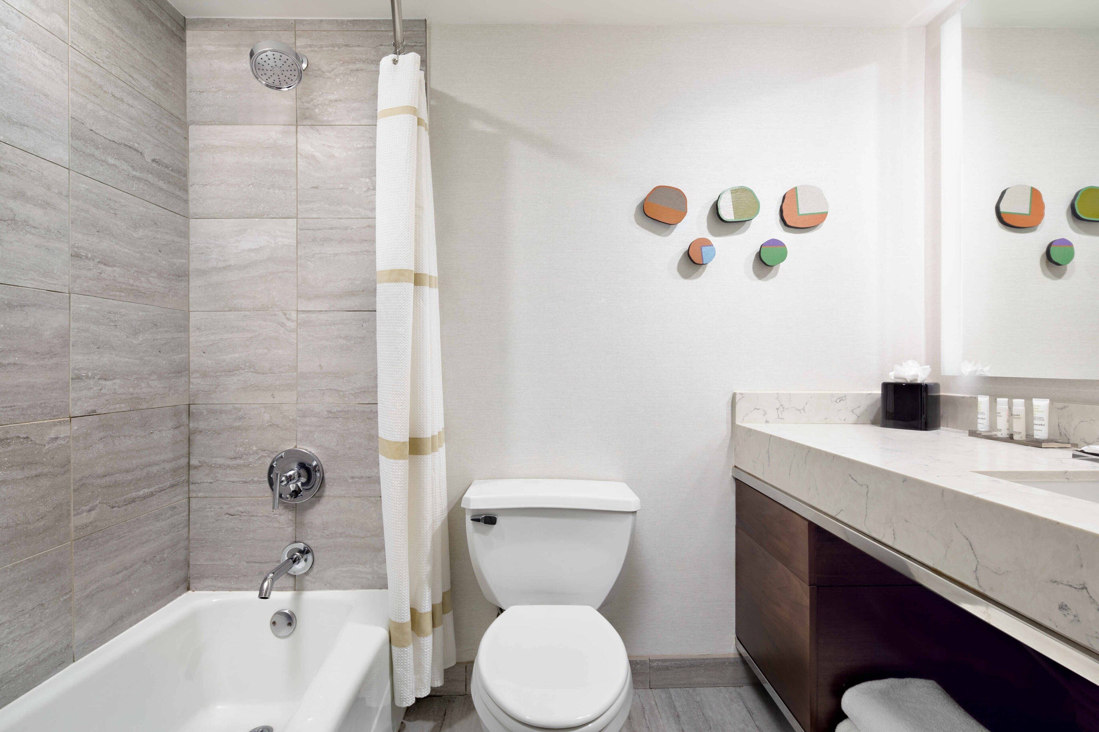 combined shower/bathtub, designer toiletries, hair dryer, towels