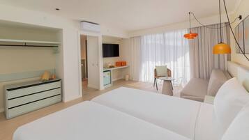 A hotel room with a large bed, a desk, a chair, and a television.