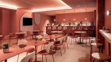 A modern restaurant with a bar area, multiple dining tables and chairs, and a flat-screen TV mounted on the wall.