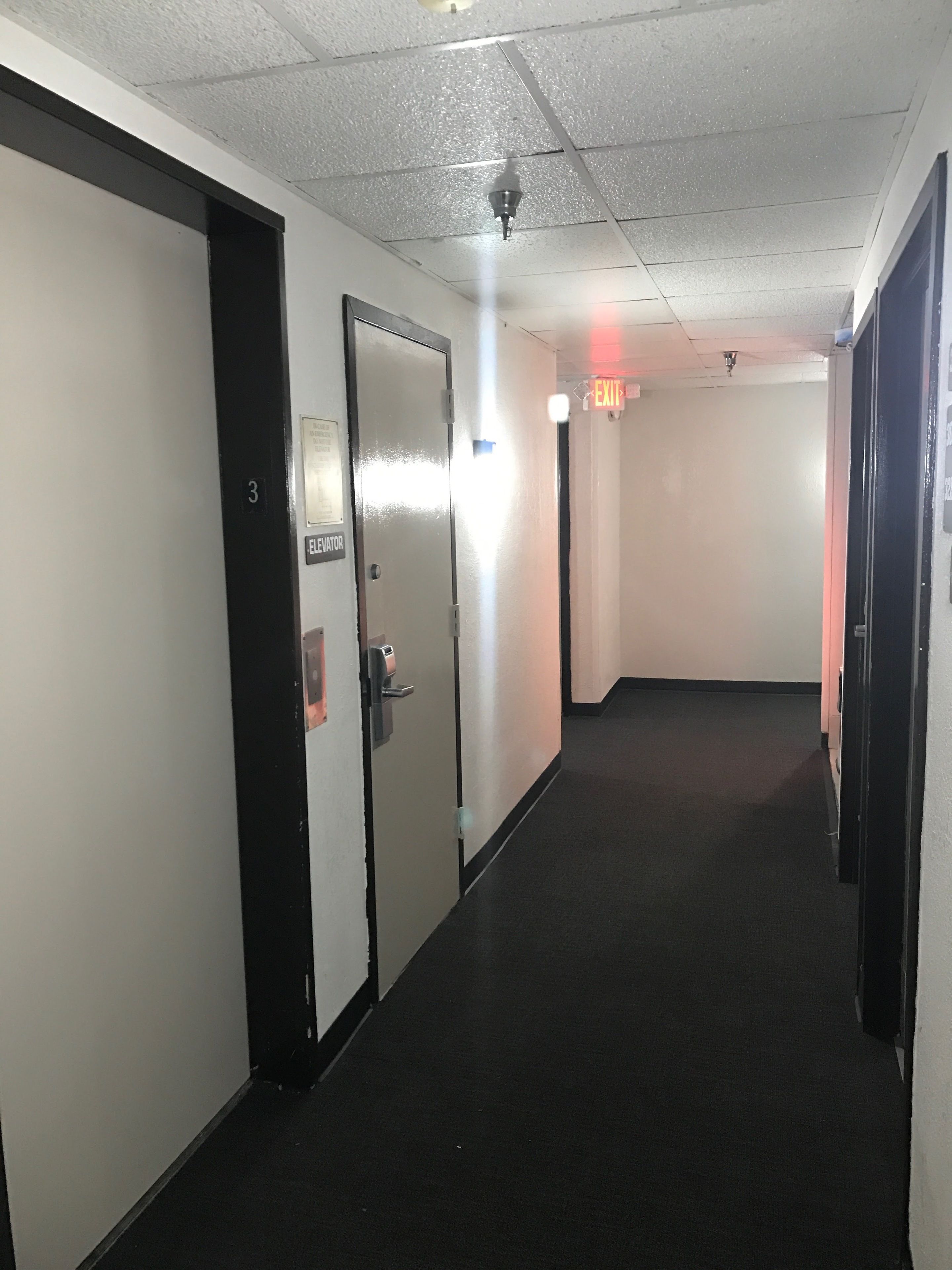 A hallway with a door labeled "Elevator" and "3" indicating the floor level.