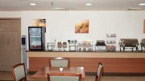 A hotel breakfast area with a refrigerator, coffee maker, toaster, and a bread display. - Comfort Suites Baton Rouge South I-10 (Baton Rouge)