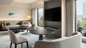 A modern hotel room with a large TV, comfortable seating, and a city view. - Sheraton Miyako Hotel Tokyo (Tokyo)