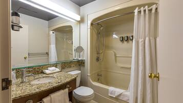 A bathroom with a sink, toilet, and bathtub.