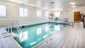 An indoor swimming pool with clear water, a tiled floor, and a wooden ceiling. - Quality Inn Pueblo North (Pueblo)