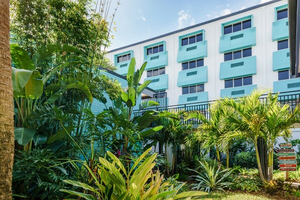 A hotel with a modern design, featuring a white facade with blue accents and multiple balconies. - Coco Key Hotel & Water Park Resort (Orlando)