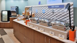 A buffet setup with labeled food stations including scrambled eggs, bacon, turkey sausage, and scrambled eggs. - Holiday Inn Express Blowing Rock South by IHG (Blowing Rock)