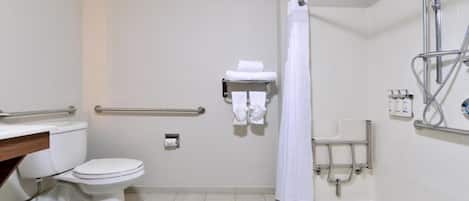 A standard bathroom with a toilet, a shower area with a grab bar, and a towel rack.
