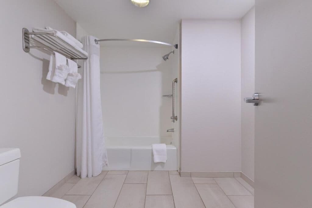 A bathroom with a bathtub, a shower, and a toilet.