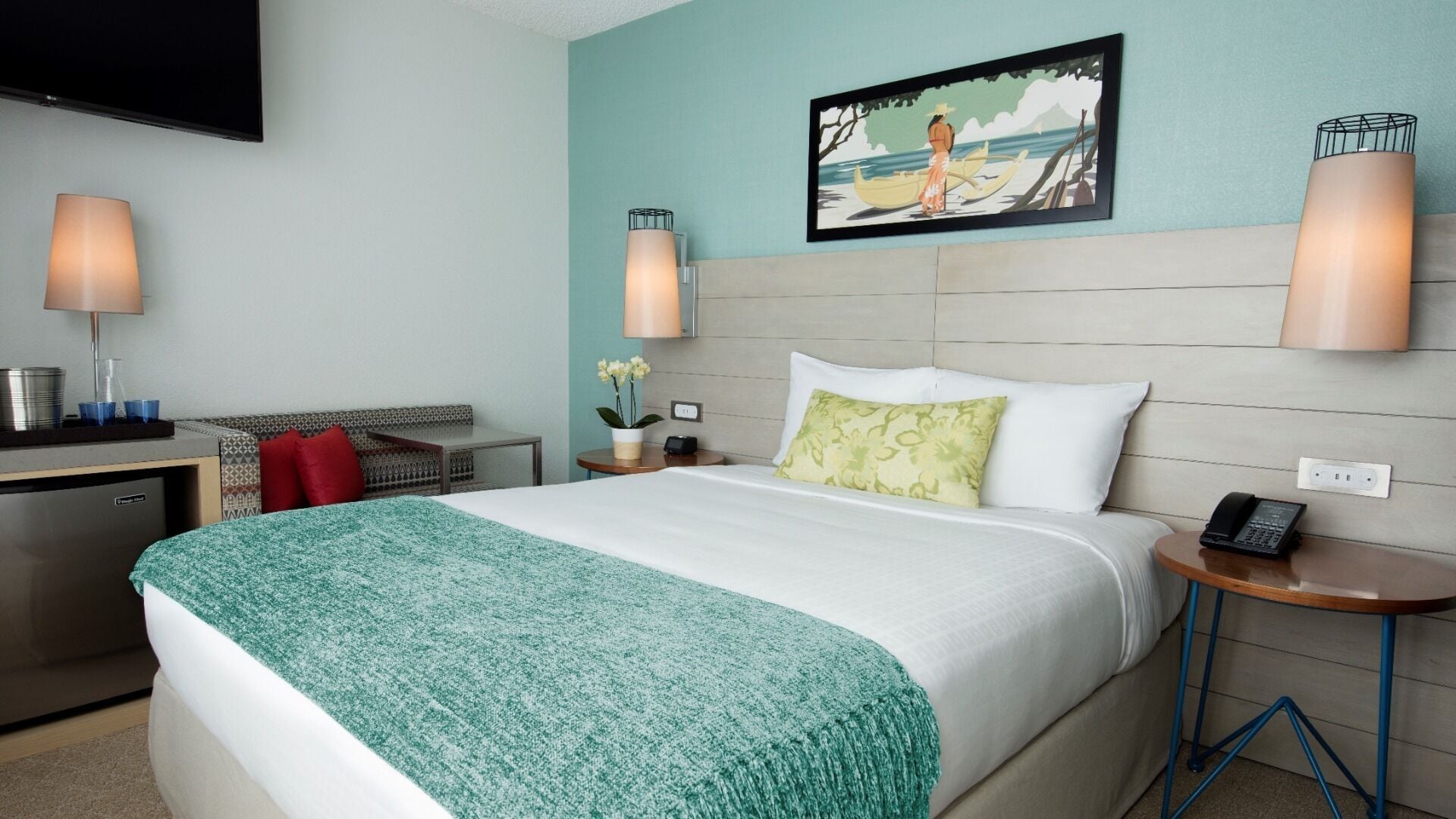 A hotel room with a bed, bedside tables, a desk, a TV, and a painting on the wall.