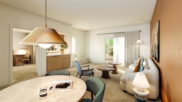 A modern hotel room with a dining area, a sofa set, and a kitchen visible through an open door.