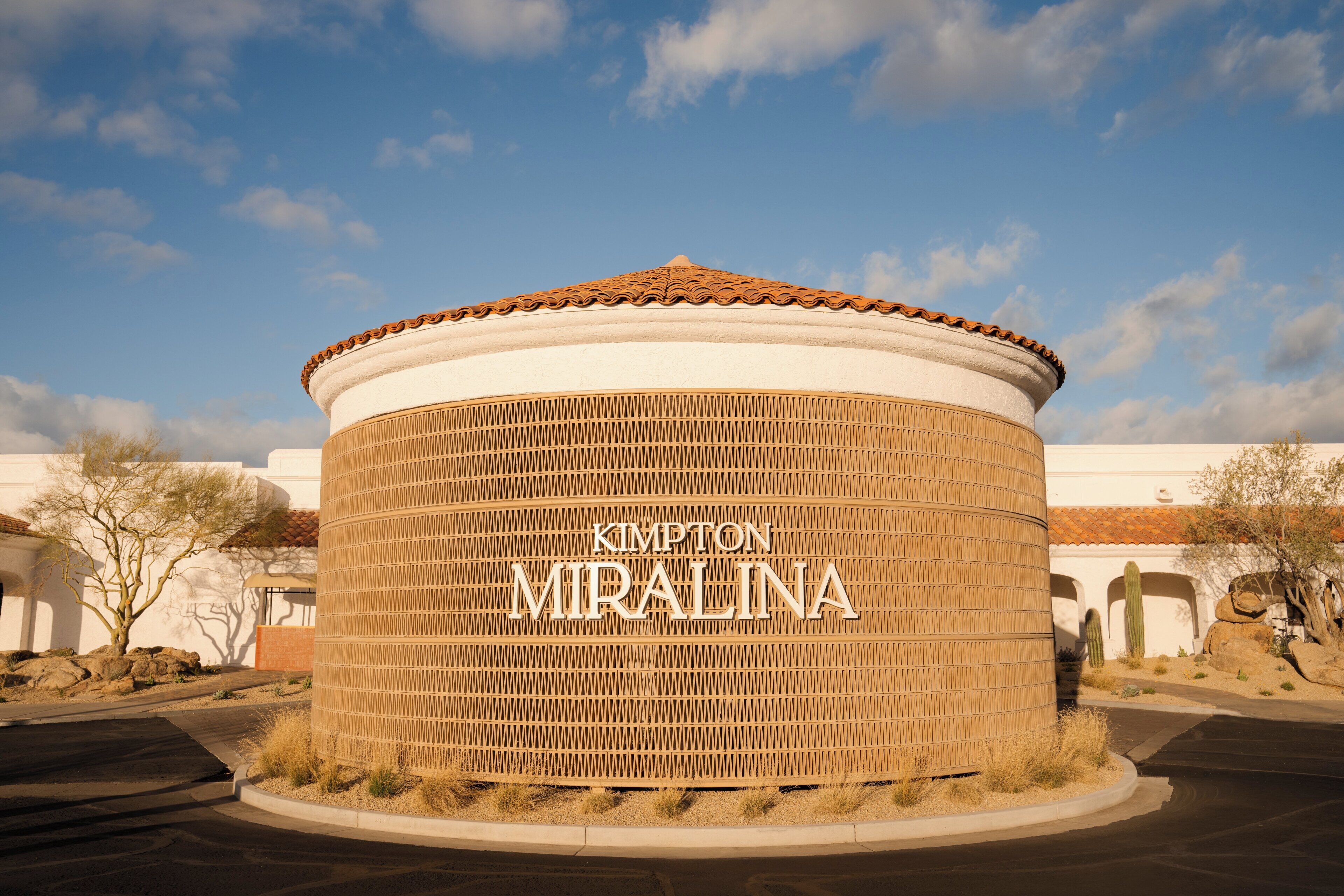 A cylindrical building with the text 'KIMPTON MIRALINA' on its side.