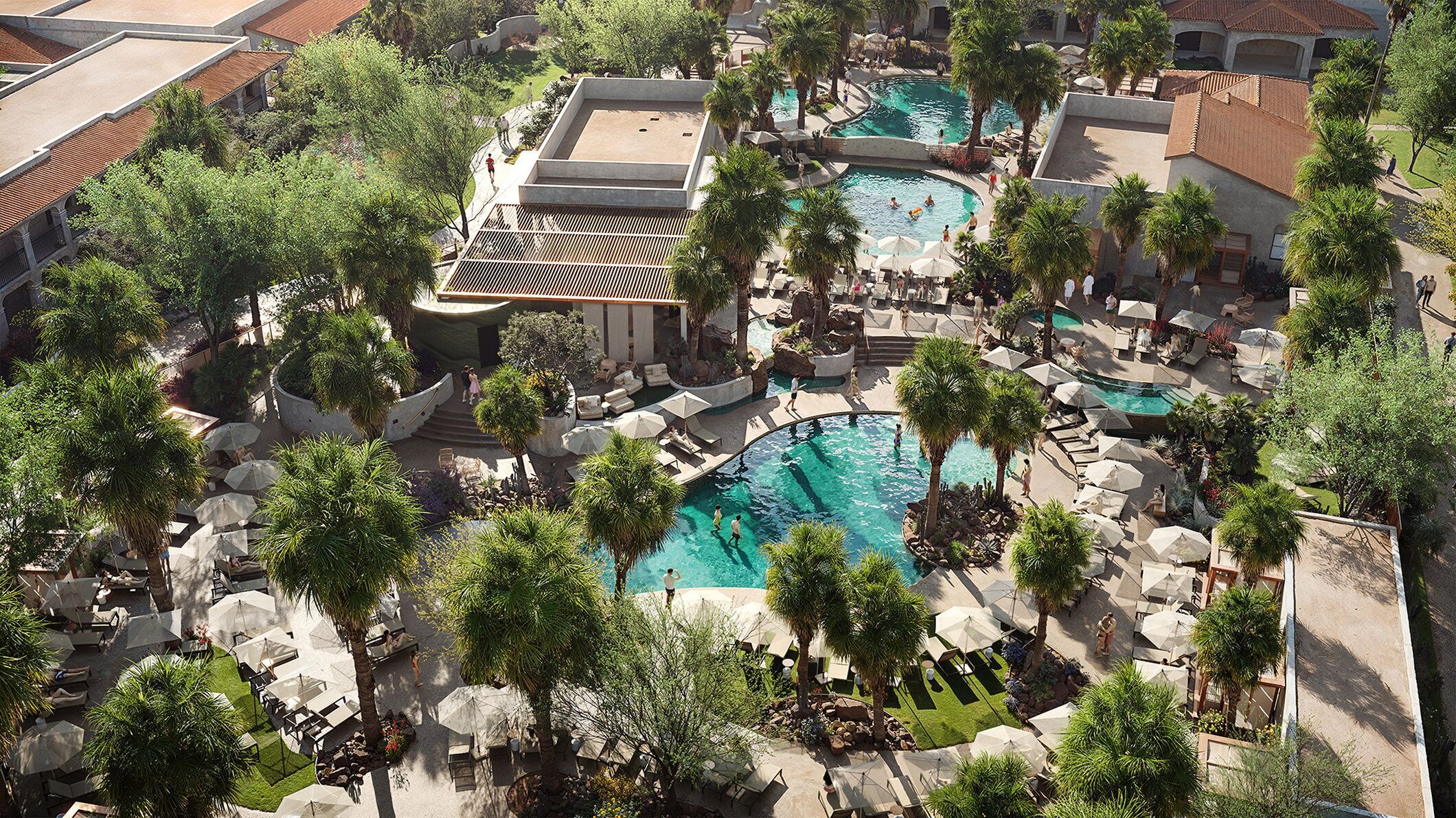 Un complexe hôtelier doté de plusieurs piscines, d’espaces de détente et de palmiers.