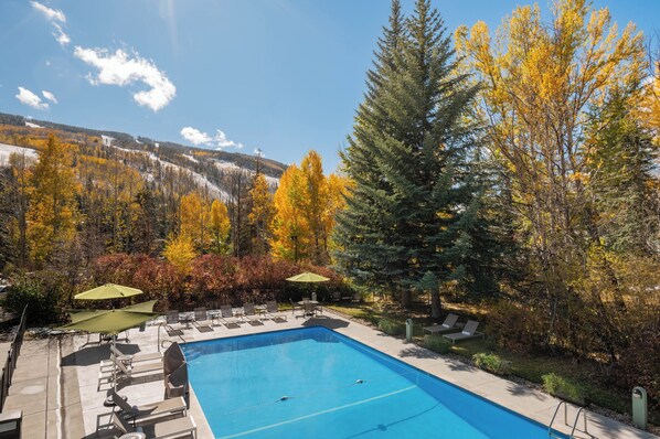 Seasonal outdoor pool, open 8:00 AM to 10:00 PM, pool umbrellas