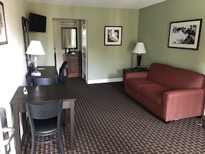 Suite, 1 King Bed, Non Smoking | Living area | 32-inch LCD TV with cable channels, TV, first-run movies