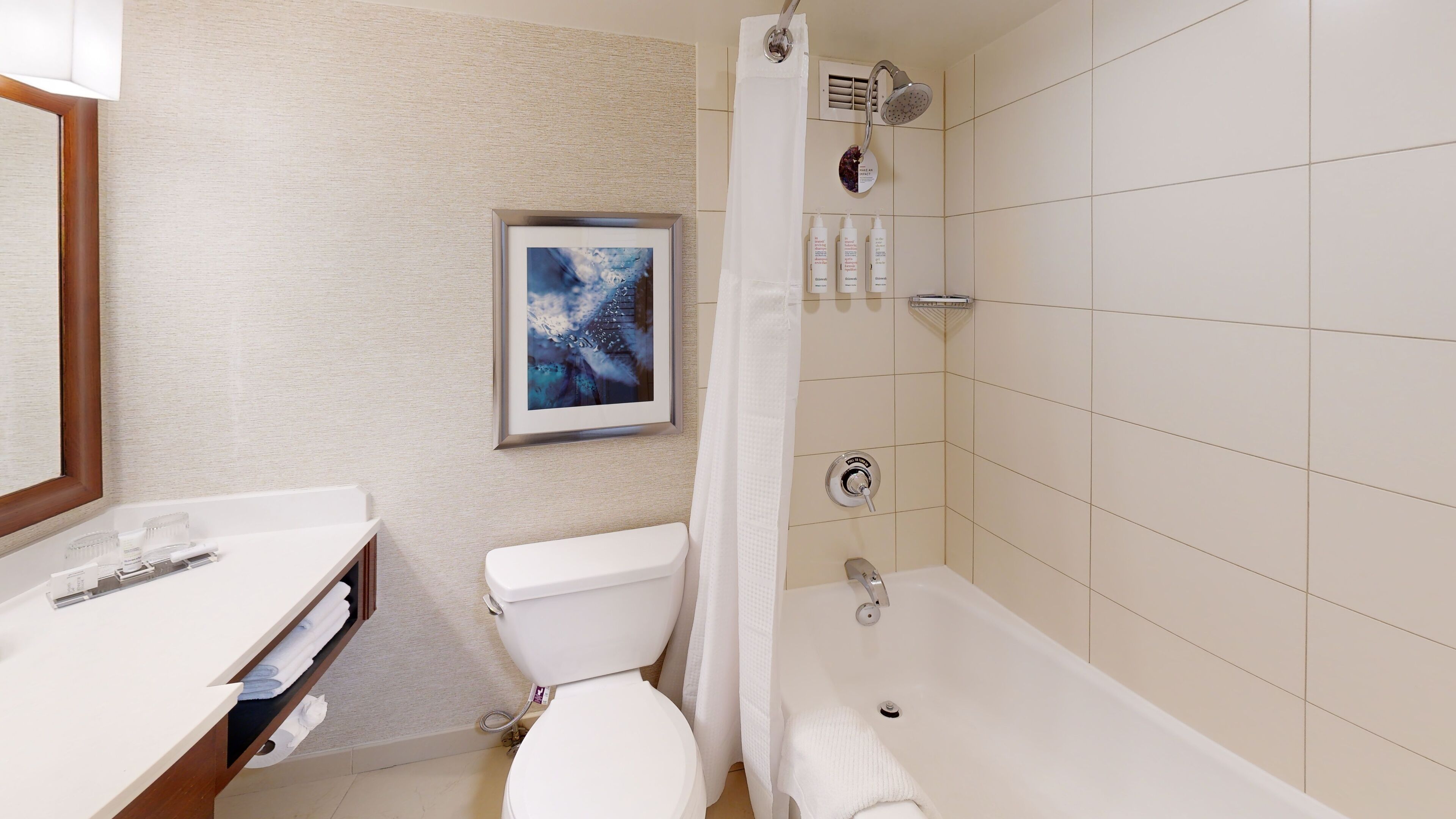 A bathroom with a toilet, sink, and bathtub.