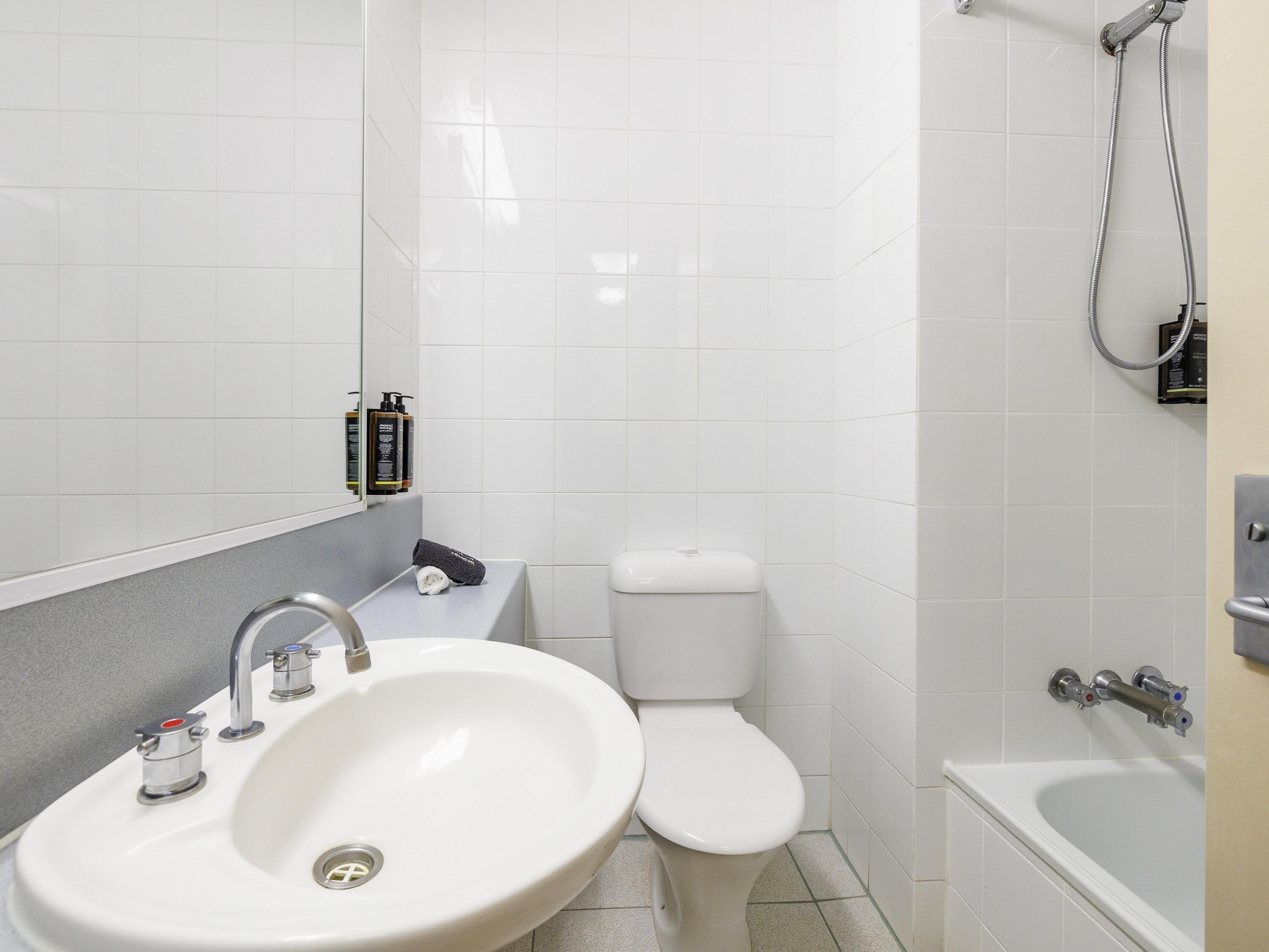 A bathroom with a sink, toilet, and bathtub.