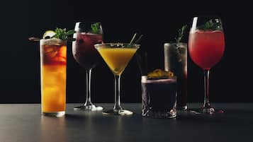 Five different cocktails in various glassware.