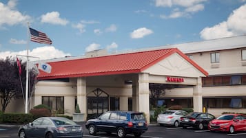 Welcome to Ramada, where guests can enjoy a convenient entrance with a glass door and ample parking.