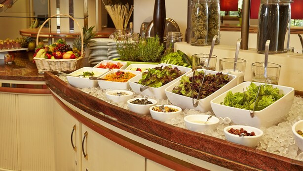 A buffet with various food items and condiments. - Sunday Hotel Bad Soden (Bad Soden am Taunus)