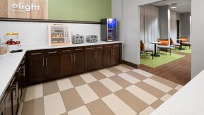 A modern kitchen with a refrigerator, toaster, and a breakfast bar.
