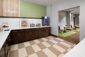 A modern kitchen with a refrigerator, toaster, and a breakfast bar.