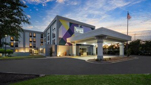 A hotel with a modern design, a gas station, and an American flag. - Spark by Hilton Decatur (Decatur)