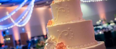 A three-tiered wedding cake with floral decorations.