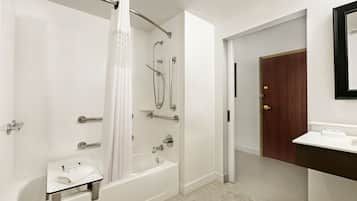 A modern bathroom with a bathtub, shower, and vanity.