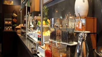 A buffet counter with various food items and condiments.