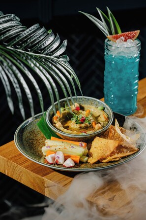 A meal with a bowl of soup, a glass of blue beverage, and a plate with various sides. - Vale do Lobo Resort (Loulé)