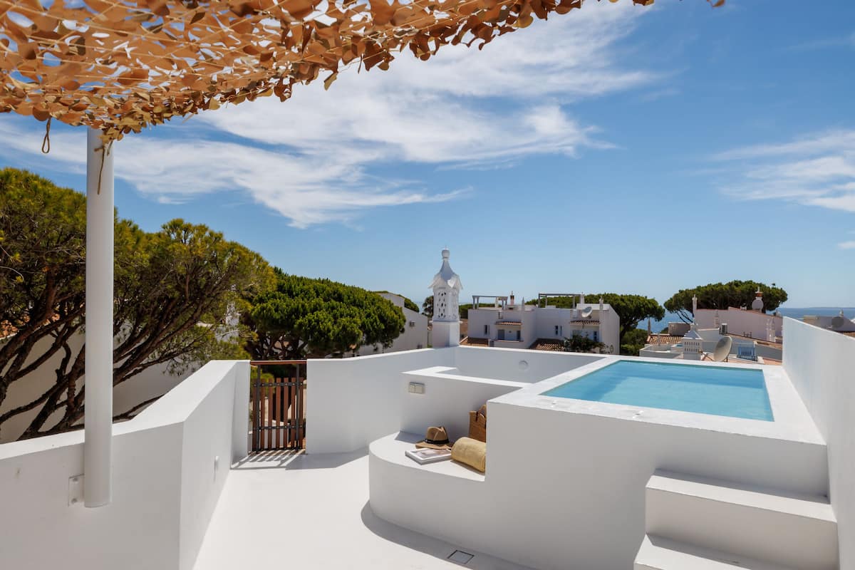 A rooftop pool area with a clear view of the surrounding buildings and trees.