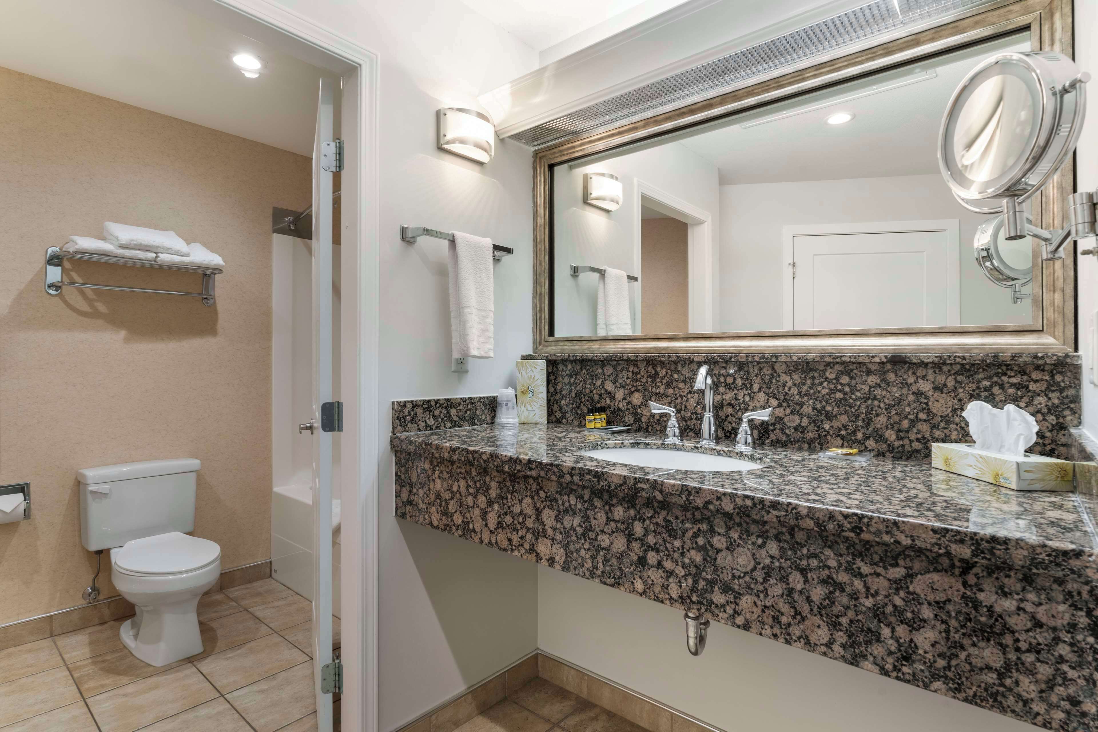 standard room, 2 queen beds, non smoking, patio (pet friendly) | bathroom | combined shower/bathtub, designer toiletries, hair dryer, towels