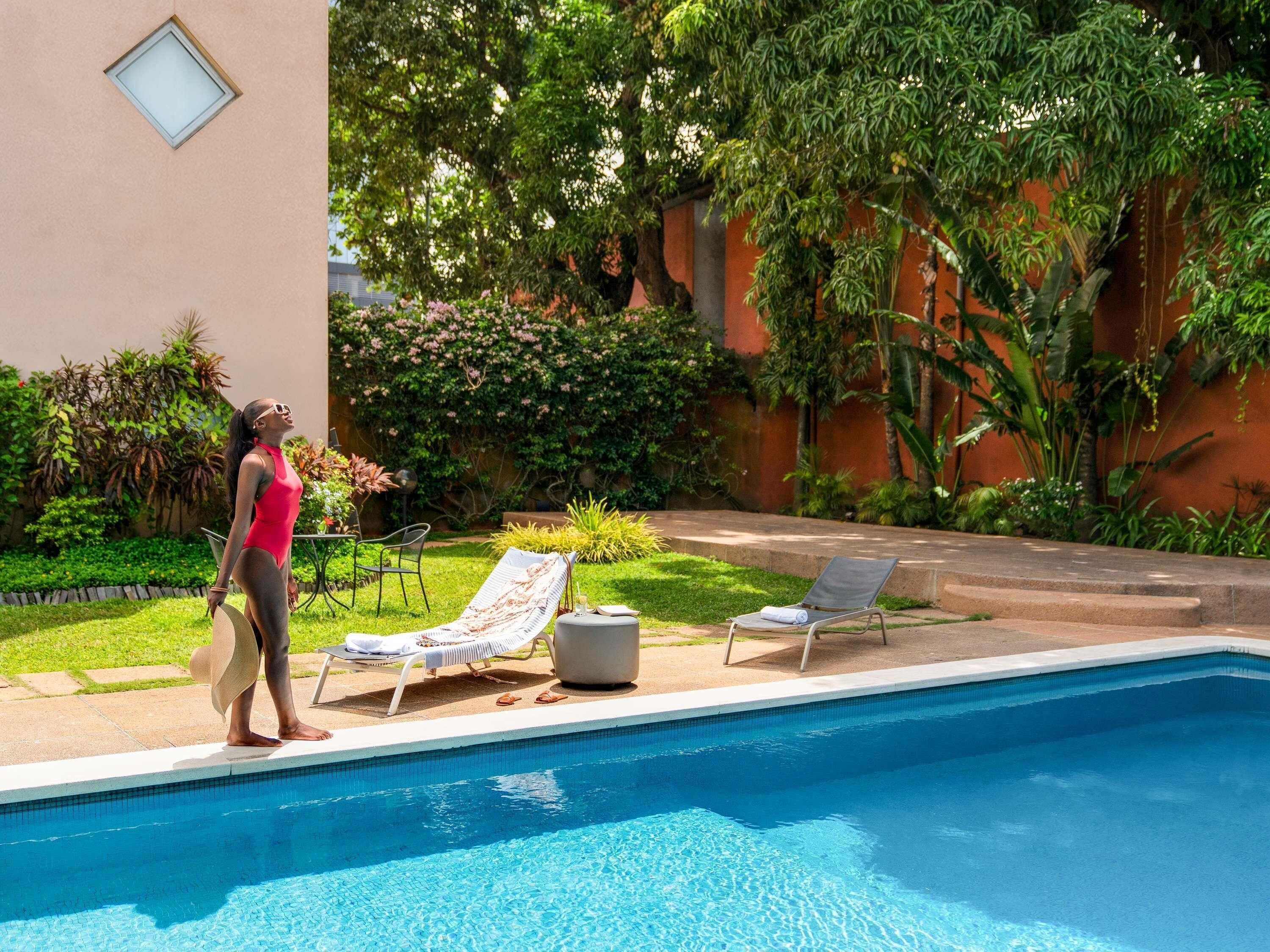 Outdoor pool, open 6:00 AM to 10:00 PM, pool loungers