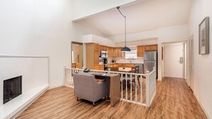 A modern apartment with a kitchen, dining area, and living room.