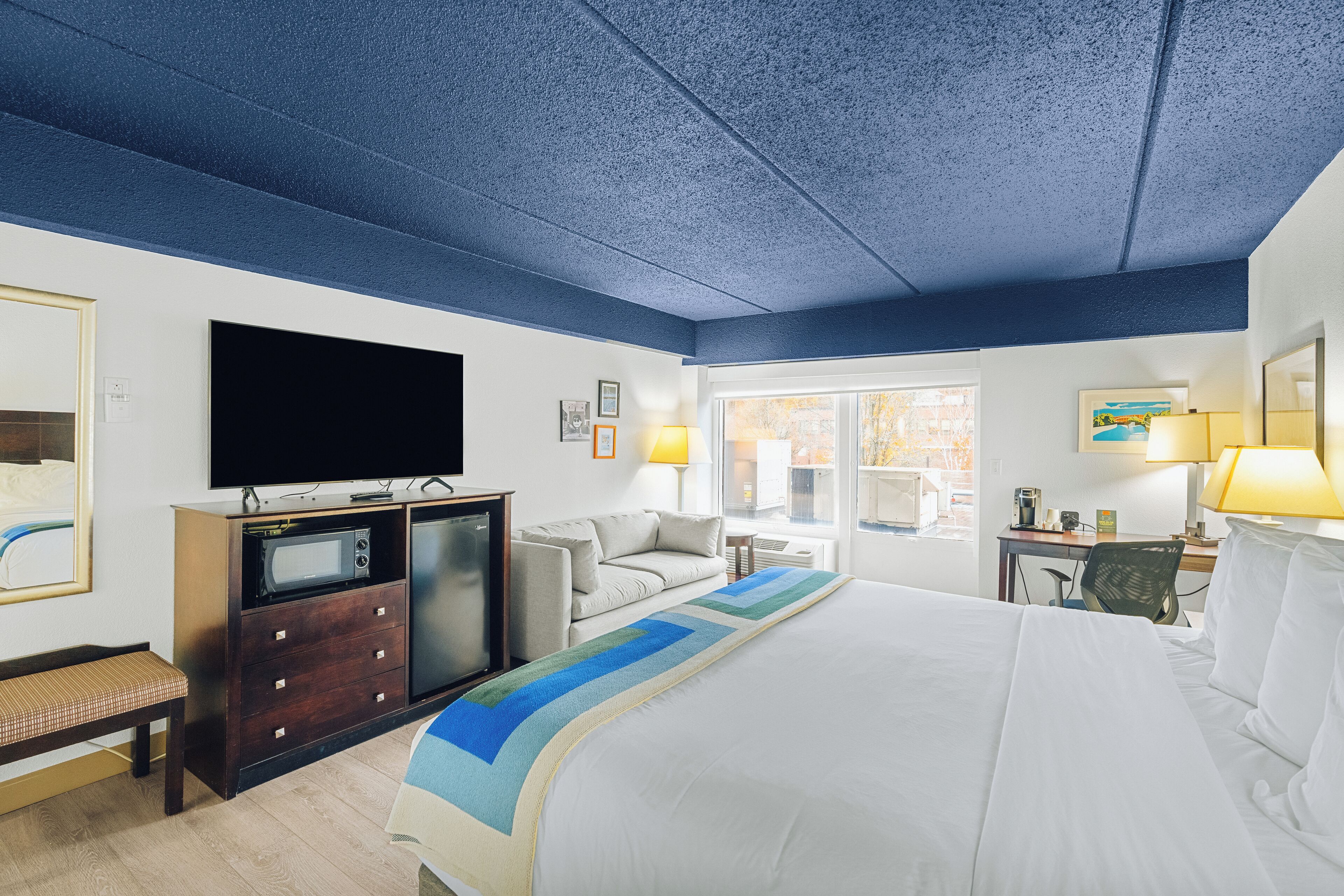 Hypo-allergenic bedding, desk, laptop workspace, blackout drapes