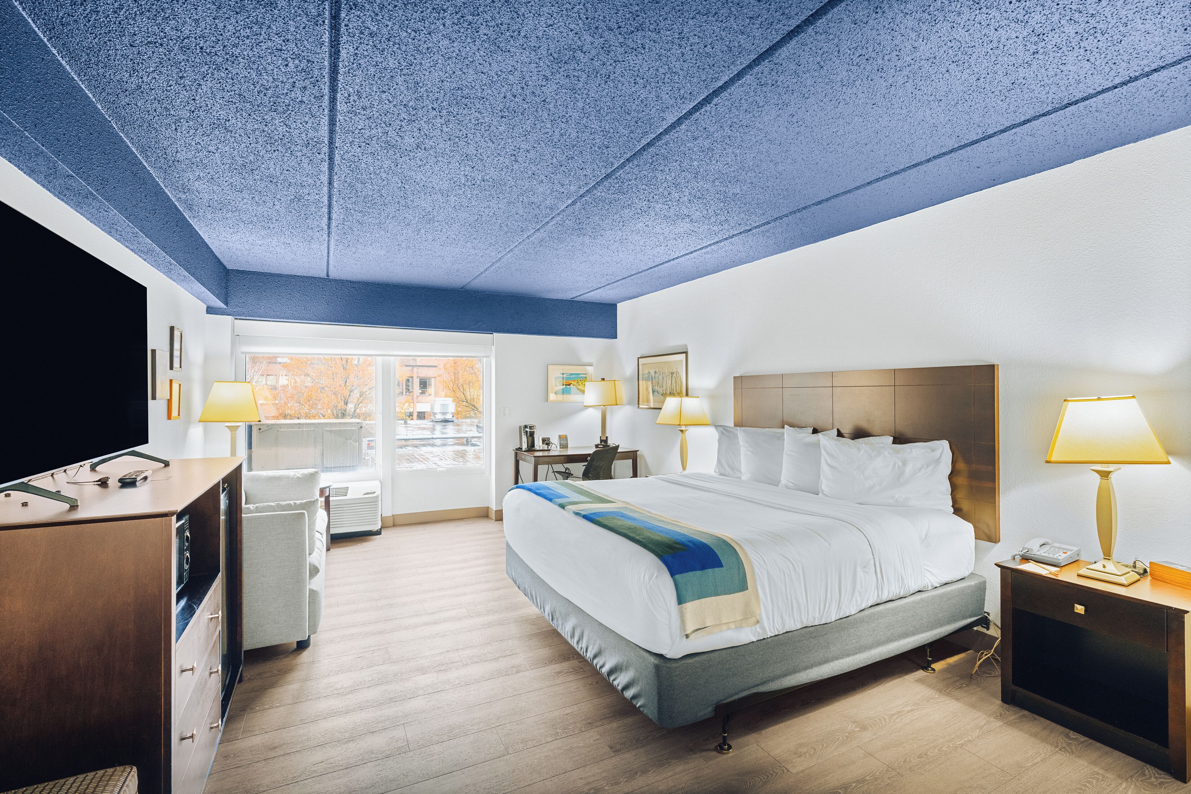 Hypo-allergenic bedding, desk, laptop workspace, blackout drapes