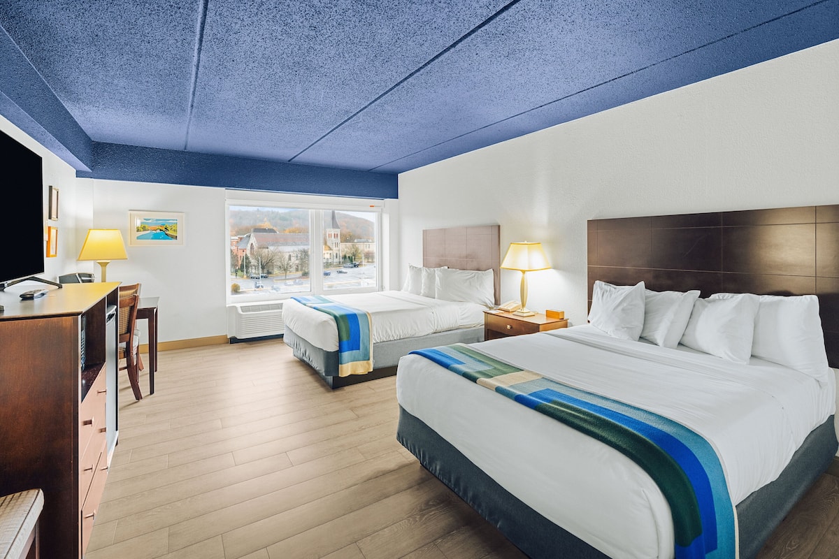 Hypo-allergenic bedding, desk, laptop workspace, blackout drapes