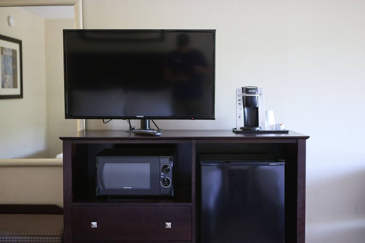 hypo-allergenic bedding, desk, laptop workspace, blackout curtains