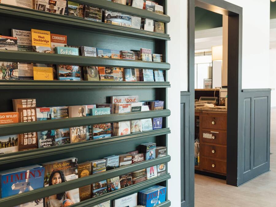 A bookshelf with various books and pamphlets, including titles like 'JIMINY' and 'Berkshire Landscapes'.