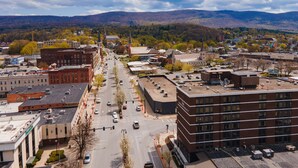 A cityscape with a prominent building labeled "The Downtown Street" featuring a modern brick facade and a flat roof.
