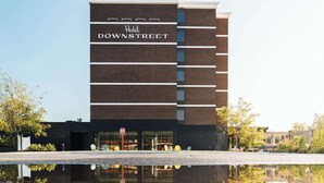 A modern hotel building with the name "Hotel Downtown" on the facade.