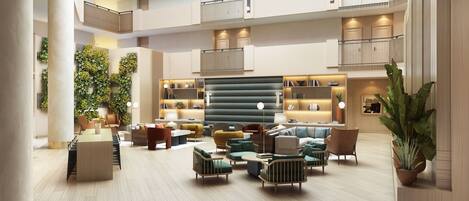 A spacious lobby with multiple seating areas, a central staircase, and a modern design with wooden accents and greenery.