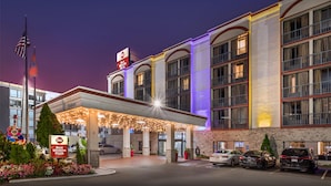 A hotel with a covered entrance, multiple floors, and a sign indicating it is part of the Best Western Plus chain.