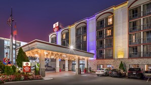 A hotel with a covered entrance, multiple floors, and a sign indicating it is part of the Best Western Plus chain.